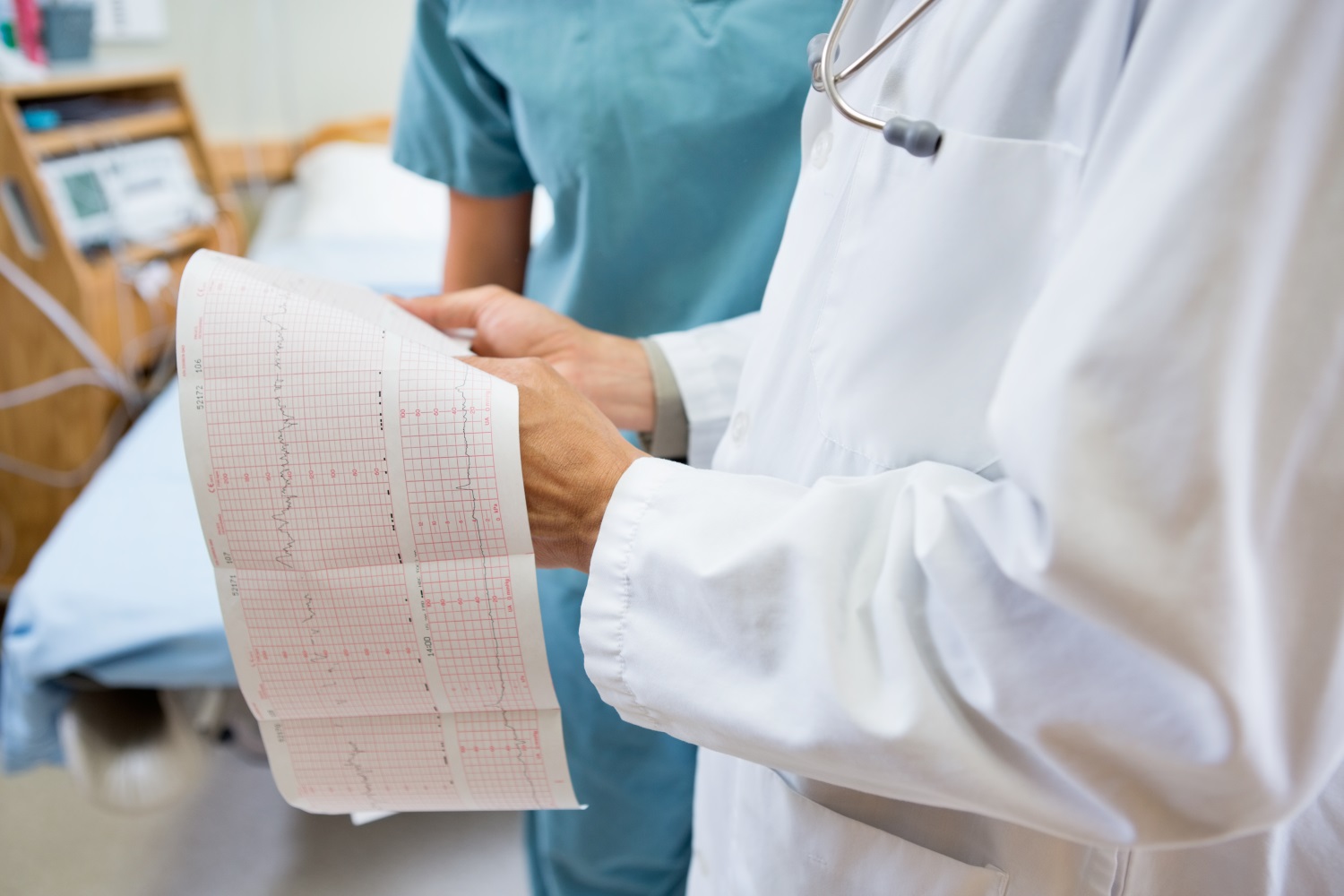 A healthcare provider holding a medical chart.